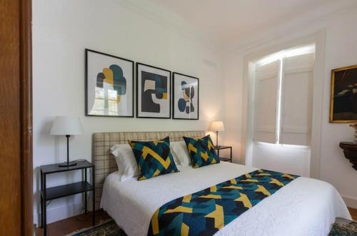 a bedroom with a bed and some pictures on the wall at SOLO ! Charme Boutique in Avis