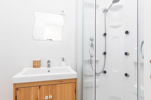 a bathroom with a sink and a shower at Caparica Balance Apartment, 2 bedroom in Costa da Caparica