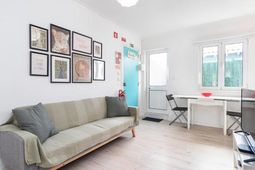 a living room with a couch and a table at Caparica Balance Apartment, 2 bedroom in Costa da Caparica