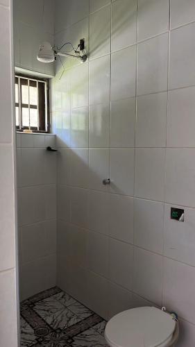 a bathroom with a shower with a toilet at Pousada Rensule in Bertioga