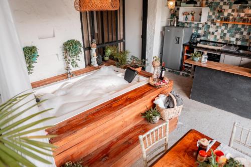 a large bed in the middle of a living room at hotel boutique Almaia 17 cerca del aeropuerto jose m cordova in Rionegro