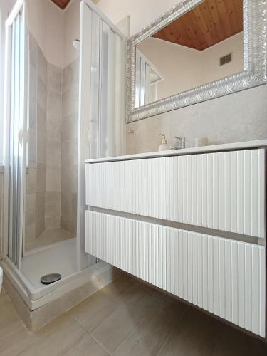 a white bathroom with a shower and a sink at Kasakiwi Apartment in Vicenza