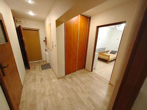 a hallway with a door and a living room at Vistula Home in Płock