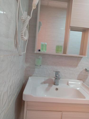a bathroom with a white sink and a mirror at Star Gate Camp in Wadi Rum