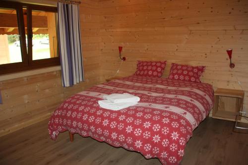 - une chambre avec un lit dans une cabane en rondins dans l'établissement Edelweiss B31, à Morgins