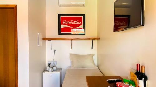 a room with a coca cola sign on the wall at Vila Bonita Guest House in Alto Paraíso de Goiás