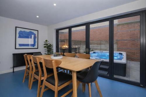 a dining room with a table and chairs and a tub at Stylish Leeds City Centre Retreat with Private Terrace & Hottub in Central Station