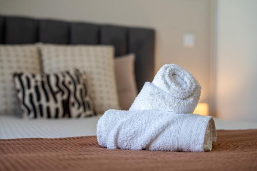 a white towel sitting on top of a bed at Golden Tide in Machico