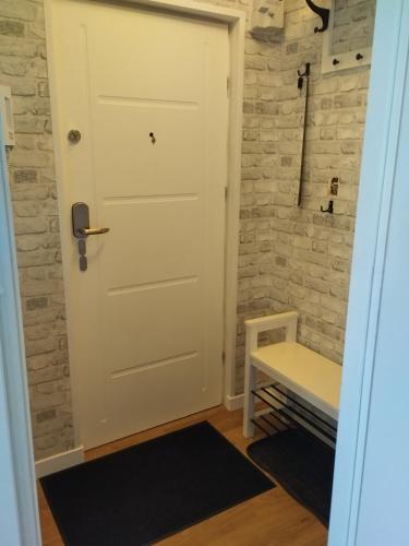 a door in a room with a brick wall at Na Sadowej in Grodzisk Mazowiecki