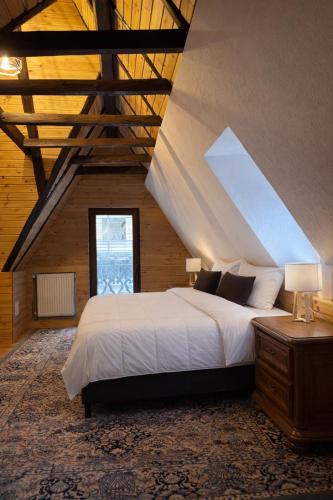 a bedroom with a large bed in a attic at Conacul Fluturilor in Sinaia