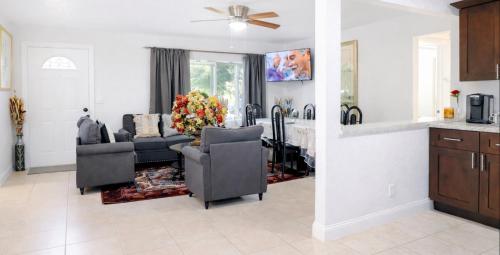 a living room with two chairs and a couch at Family-Friendly Beach Home in West Palm Beach, FL in West Palm Beach