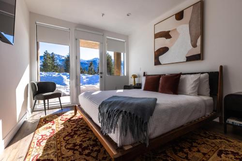 a bedroom with a large bed and a window at The Sierra House in Mammoth Lakes