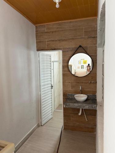 a bathroom with a sink and a mirror at Sobrado 3 Praias in Ubatuba