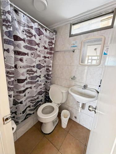 a bathroom with a toilet and a sink at Hostal Posada Del Sol in Guayaquil