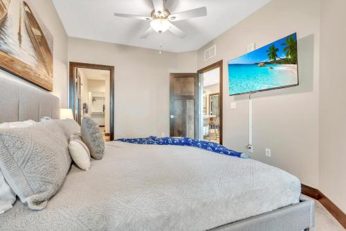 a bedroom with a bed with a ceiling fan at Bridges Bay Resort Bayside Building 203 in Arnolds Park