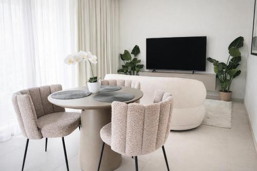 a living room with a table and two chairs at IsLe Royal Suites By Mercury Tower in St. Julianʼs