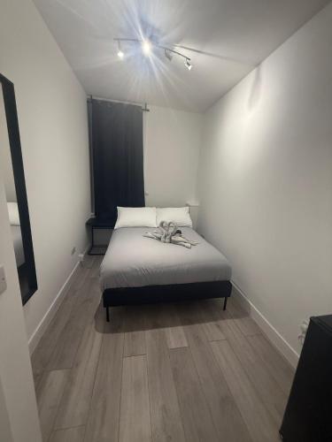 a bedroom with a bed with a ceiling fan at Balham in London