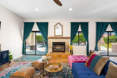 a living room with a blue couch and a fireplace at Moroccan Desert Oasis -Salt Pool - Spa - Games in Bermuda Dunes