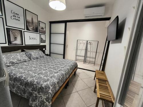 a bedroom with a bed and a flat screen tv at Casa André Imola in Imola