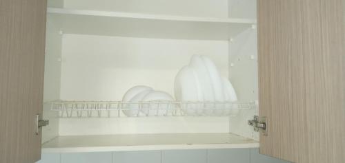 a cupboard with plates and dishes on a shelf at elia patra apartment 2 in Patra