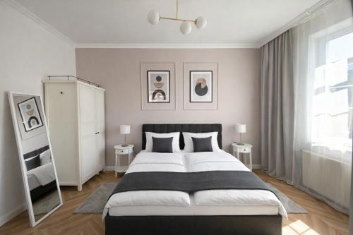 a bedroom with a large bed and a window at PIASKI 4 - Boutique stay in Gdańsk