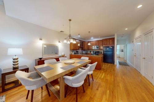 a kitchen and dining room with a wooden table and chairs at 3-Bed 2-Bath Brookline Village Townhome w Deck in Brookline