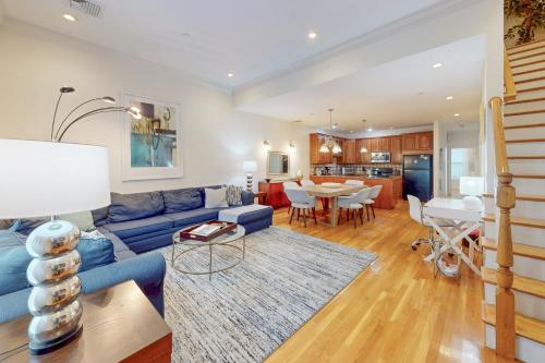 a living room with a blue couch and a table at 3-Bed 2-Bath Brookline Village Townhome w Deck in Brookline