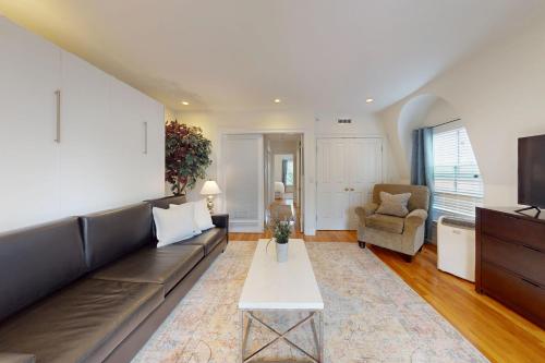 a living room with a couch and a tv at 3-Bed 2-Bath Brookline Village Townhome w Deck in Brookline
