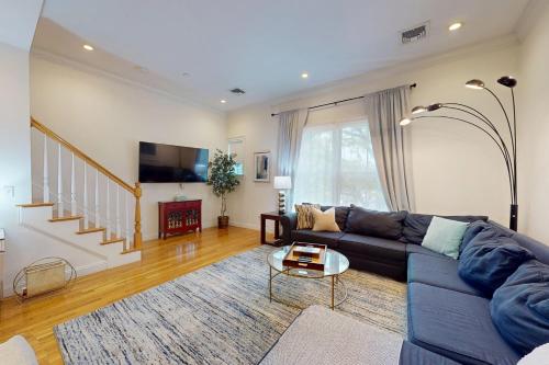 a living room with a couch and a table at 3-Bed 2-Bath Brookline Village Townhome w Deck in Brookline