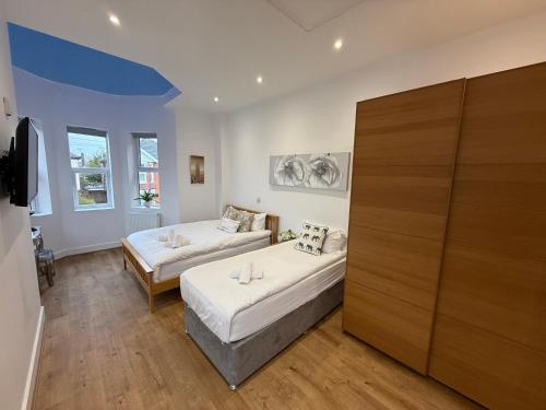 a large room with two beds and a couch at Holiday Home Hot Tub & Sauna in Bournemouth