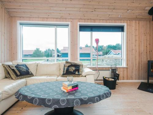 a living room with a couch and a coffee table at 4 star holiday home in Ulfborg in Fjand Gårde