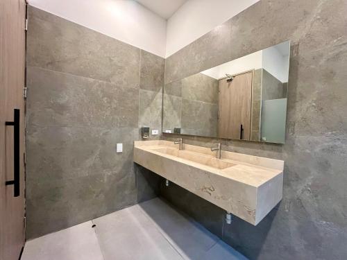 a bathroom with a sink and a mirror at BQ84 Urban Hotel in Barranquilla
