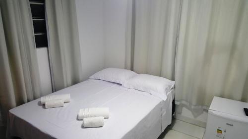 a white bed with two rolls of toilet paper on it at Flat Visual do Porto in Fernando de Noronha