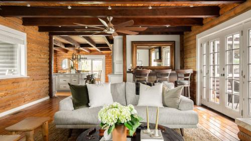 a living room with a couch and a ceiling fan at Chateau Syrah by AvantStay Picturesque Estate w Pool Hot Tub Table Tennis Pool Table New Pickleball Court Basketball hoop in Temecula