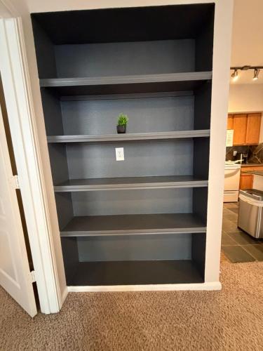 a built in book shelf in a kitchen at Minimalist cozy stay in Houston in Houston