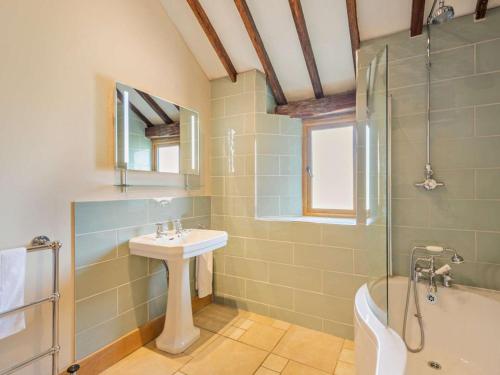 a bathroom with a sink and a shower and a tub at 5 Bed in Ashford oc-76428 in Smarden