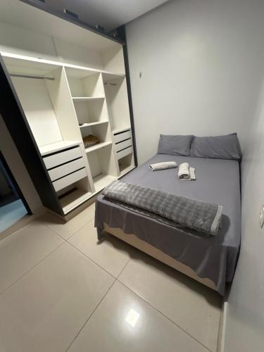 a bedroom with a bed and a large mirror at Espaço Atlântico in Goiânia