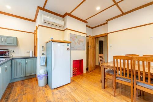 a kitchen and dining room with a refrigerator and a table at Kurow Escapes - Holiday Home in Kurow