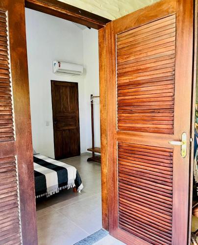a door leading to a bedroom with a bed at Relax Private Room - Santo André, BA in Santo André