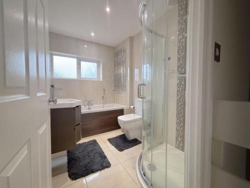 a bathroom with a toilet and a sink and a shower at 6 Bed home near to Birmingham Nec Airport 6 miles from city centre in Marston Green
