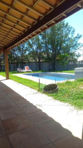 a swimming pool in a yard with a patio at Apoena in Conde