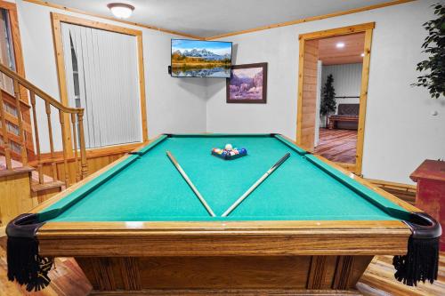 a pool table in a living room with at Airy Alto Escape Deck Games Views in Sun Valley