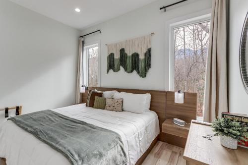 a bedroom with a large bed and a window at Mtn-View 'Hidden Falls' Cabin w/ Hot Tub & Deck in Andrews