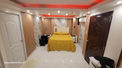 a bedroom with a bed in the middle of a room at Obynb in Santo Domingo