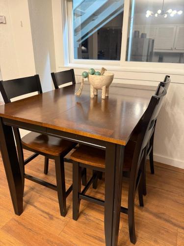 a dining room table with chairs and a vase on it at High Pines Haven in Angel Fire