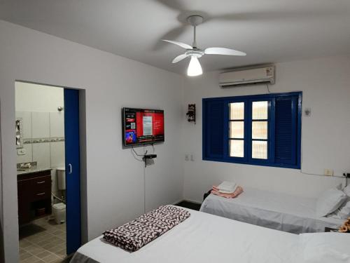 a bedroom with two beds and a ceiling fan at Refúgio Sereno São Seba in São Sebastião