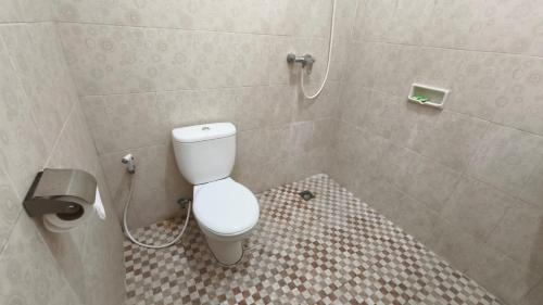 a bathroom with a white toilet in a shower at Saphala Suites Secondfloor in Seminyak