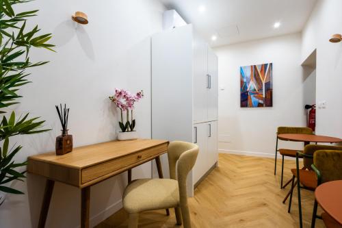 a dining room with a wooden table and chairs at Barberini Design Suites in Rome