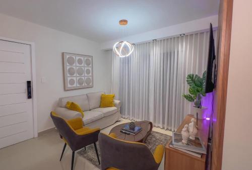 a living room with a couch and a table at San Isidro Urban suite in Juan López