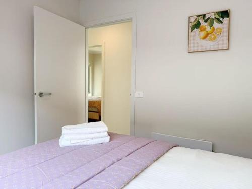 a bedroom with a bed with purple sheets and a mirror at Modern Home Canal Berwick in Berwick